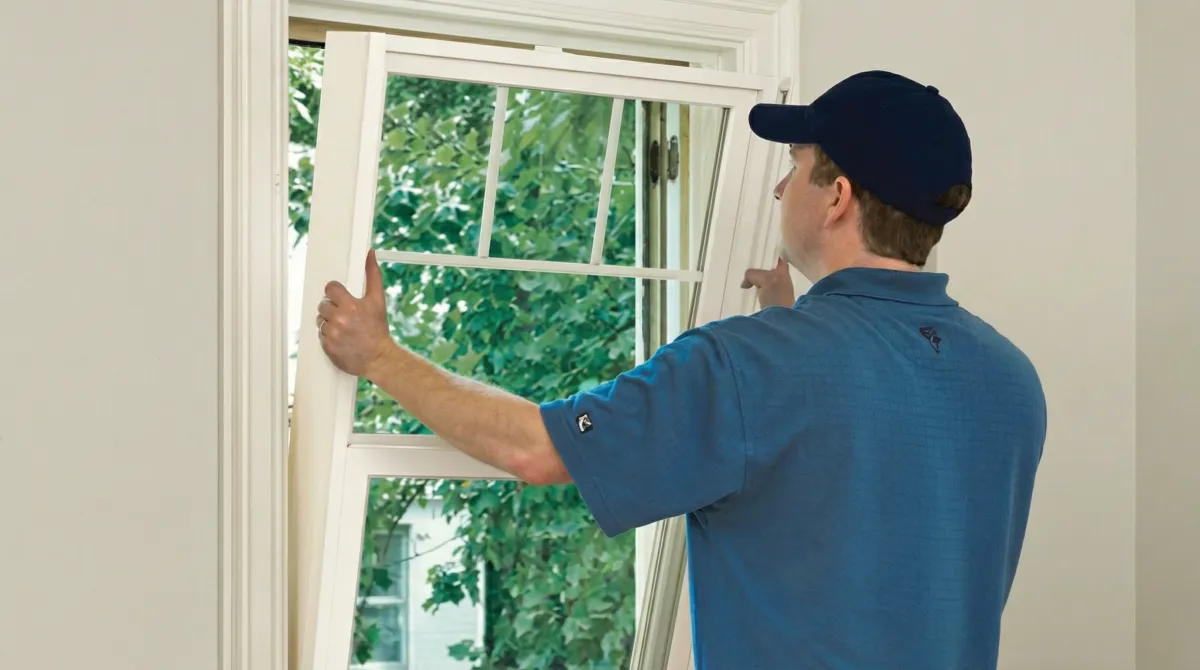 Professional contractors performing a residential window insulation and replacement service in Syracuse, NY